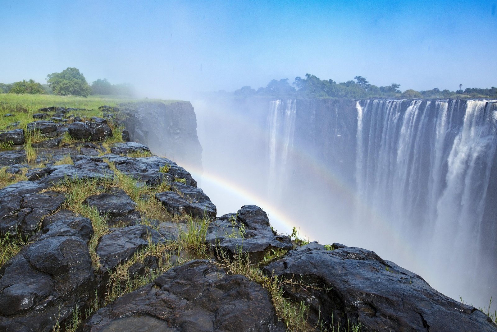 Rainbow rising above Victoria Falls